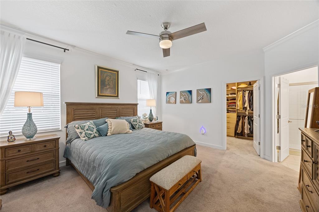 5513 Little Path Drive Wimauma, FL 33598 - Photo 17 of 40 a bedroom with a bed a dresser and a chandelier