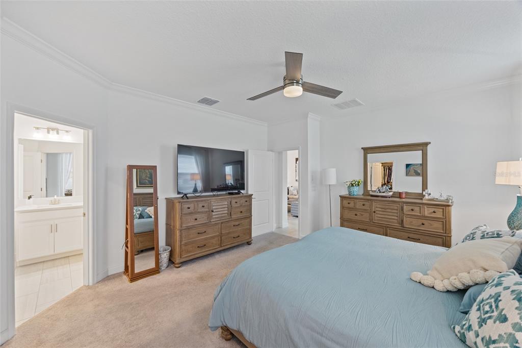 5513 Little Path Drive Wimauma, FL 33598 - Photo 18 of 40 a bedroom with a large bed and a dresser