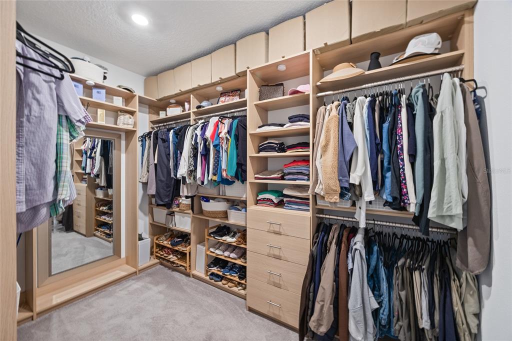 5513 Little Path Drive Wimauma, FL 33598 - Photo 19 of 40 a view of walk in closet with clothes and shoes