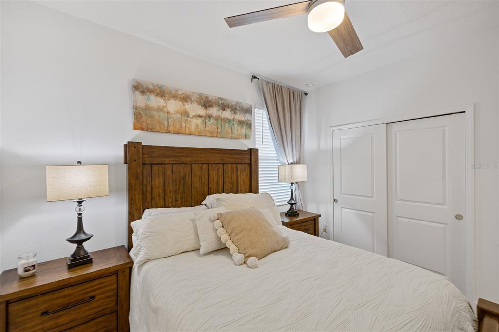 5513 Little Path Drive Wimauma, FL 33598 - Photo 22 of 40 a bedroom with a bed and a chandelier