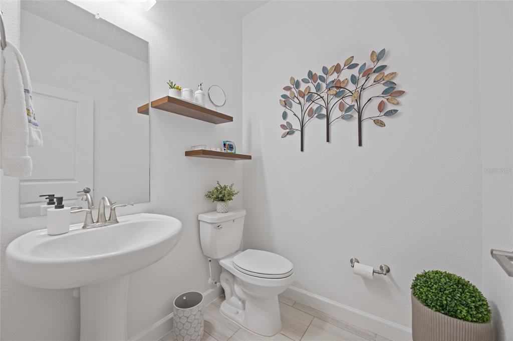 5513 Little Path Drive Wimauma, FL 33598 - Photo 28 of 40 a bathroom with a toilet sink and mirror