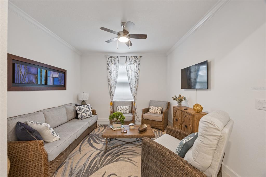 5513 Little Path Drive Wimauma, FL 33598 - Photo 7 of 40 a living room with furniture and a flat screen tv