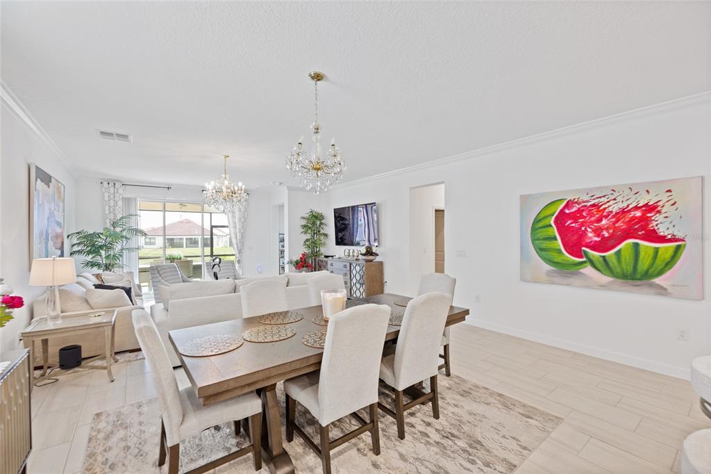 5513 Little Path Drive Wimauma, FL 33598 - Photo 10 of 40 a view of a dining room with furniture wooden floor and a chandelier