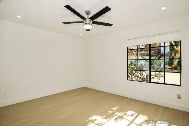 a view of a livingroom with a chandelier and a ceiling fan