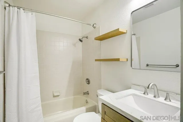 a view of a bathtub and potted plants
