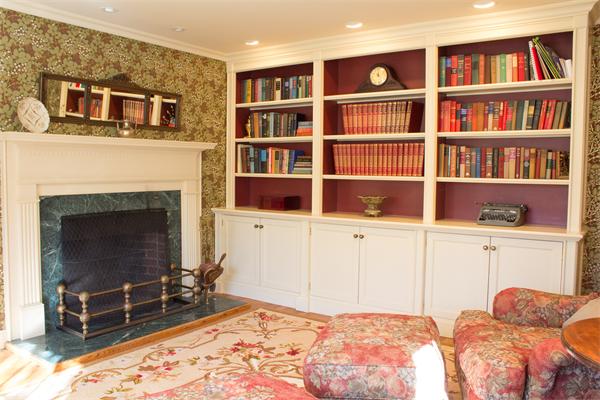 10 Cushing Road Wellesley, MA 02481 - Photo 5 of 20 a bedroom with a bed a fireplace and a book shelf