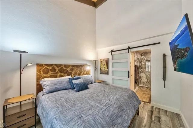 a bed sitting in a bedroom next to a window