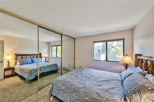 a bedroom with a bed and large window