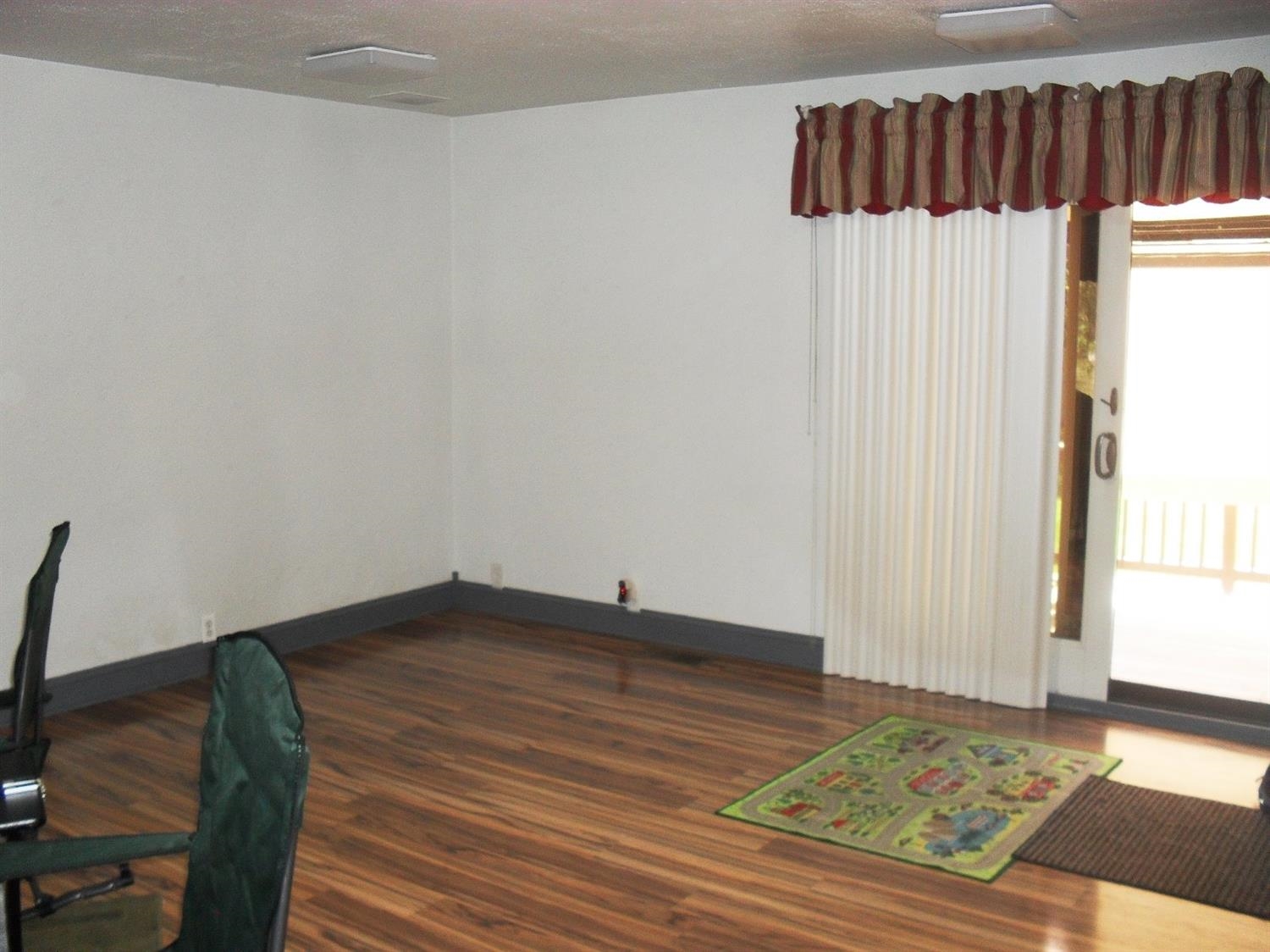 9006 Kleinman Road Highland, IN 46322 - Photo 5 of 10 a view of a livingroom with wooden floor and a rug