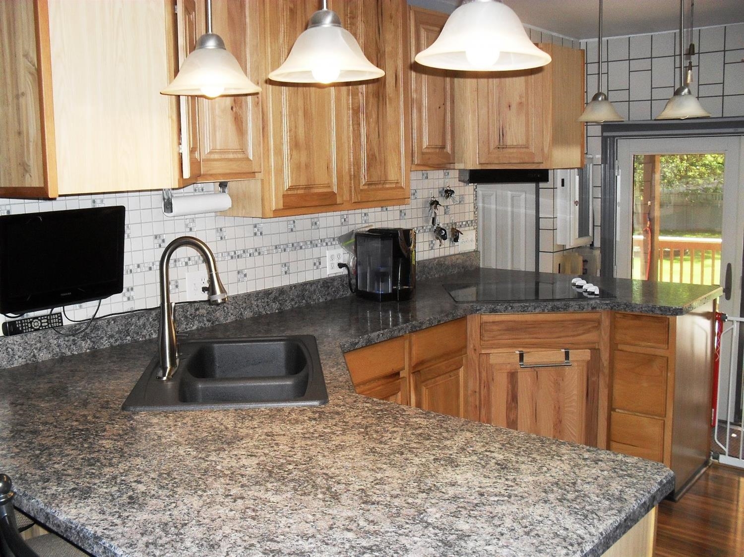 9006 Kleinman Road Highland, IN 46322 - Photo 7 of 10 a kitchen with granite countertop a sink and a stove