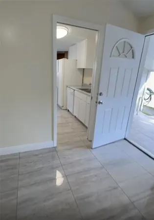a kitchen with granite countertop white cabinets and white appliances
