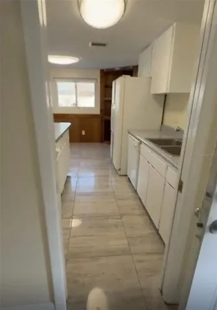 a view of a room with wooden floor and white walls