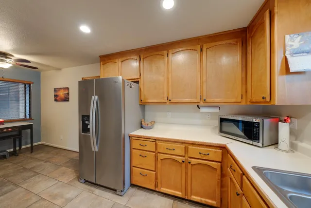 a kitchen with stainless steel appliances granite countertop a refrigerator and a sink