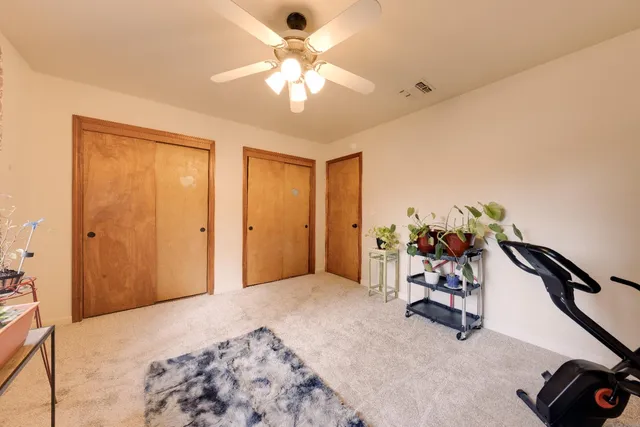 a view of a bedroom with a bed and a chandelier