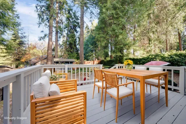 a view of a chairs and table on the balcony