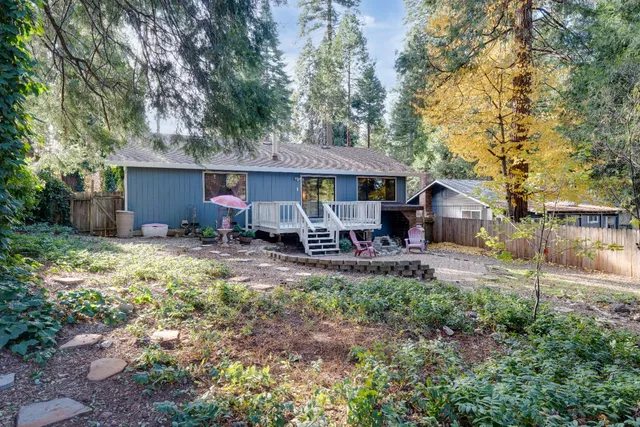 a view of a house with backyard and sitting area