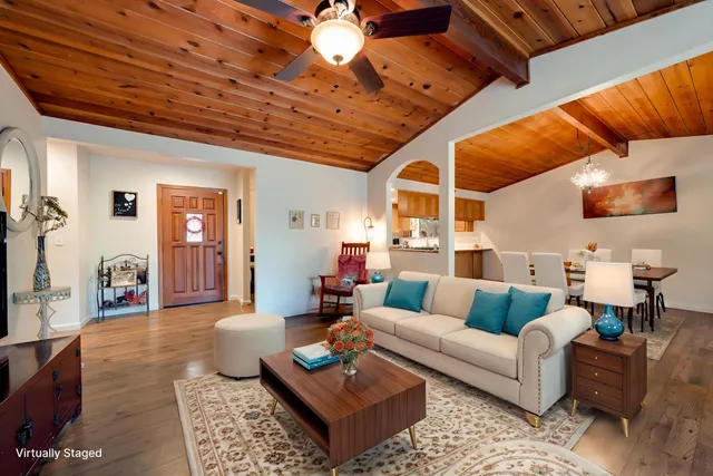a living room with furniture a rug and a chandelier
