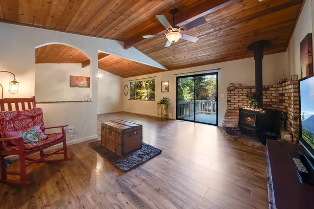 a living room with furniture wooden floor and window