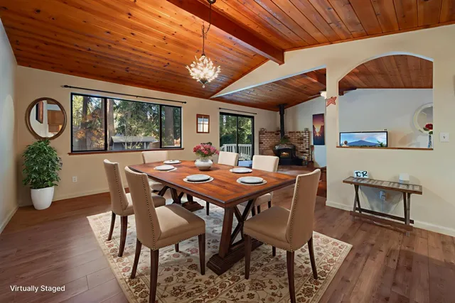a dining room with a wooden table and chairs