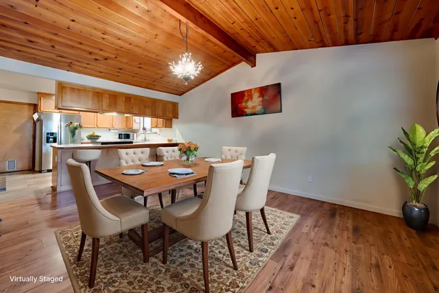 a dining room with a wooden table and chairs