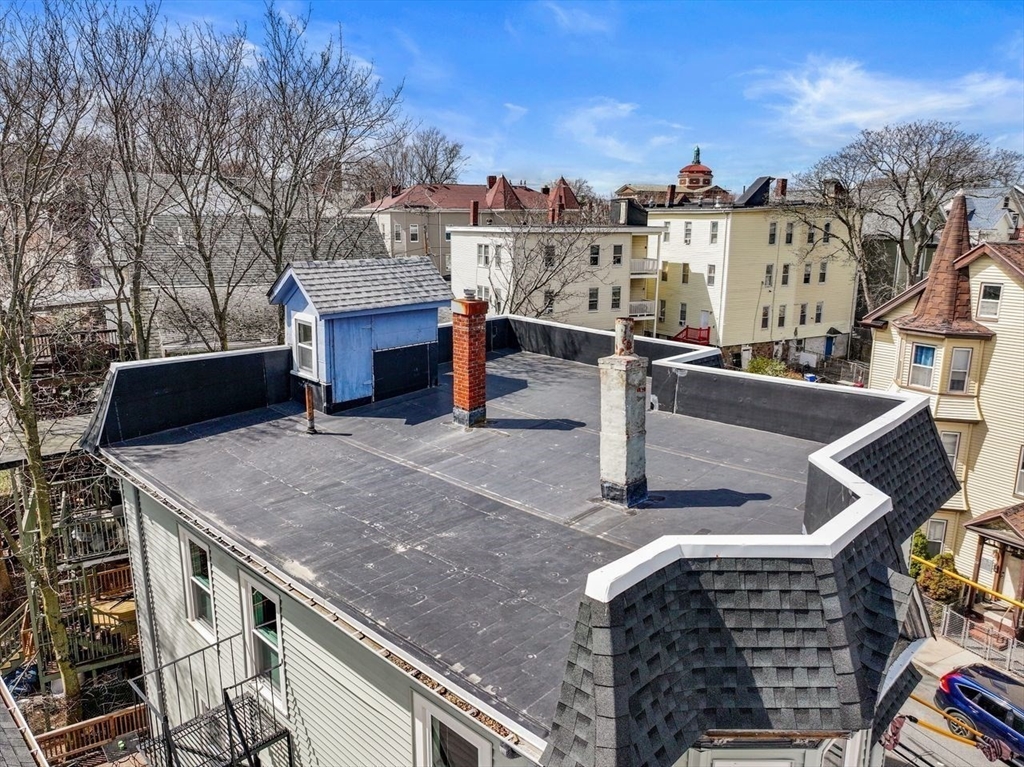 26 Armstrong Street, Unit 3 Boston, MA 02130 - Photo 13 of 17 a view of a patio with couches fire pit and a barbeque grill with large trees