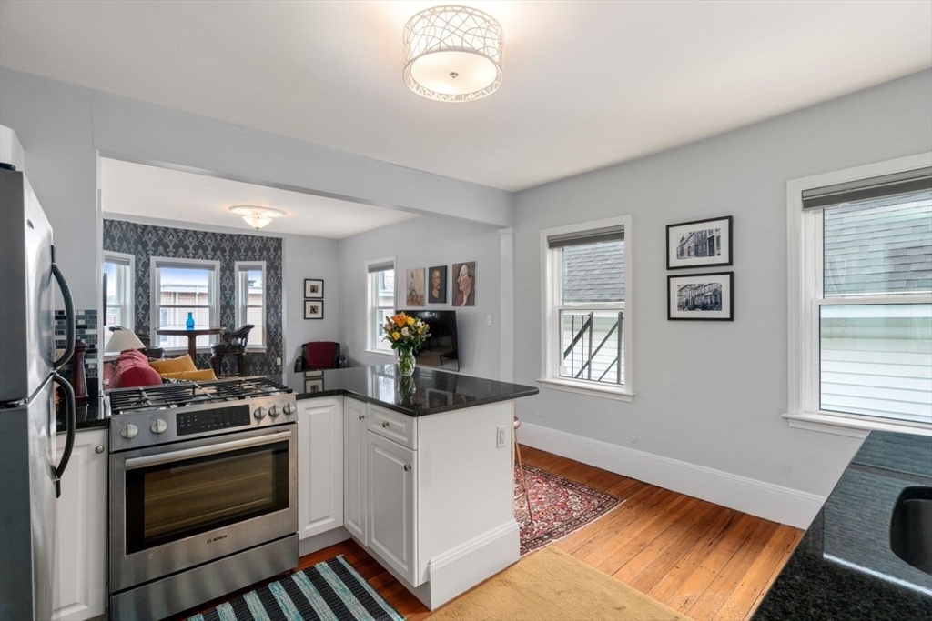 26 Armstrong Street, Unit 3 Boston, MA 02130 - Photo 2 of 17 a view of a kitchen with stove and cabinets