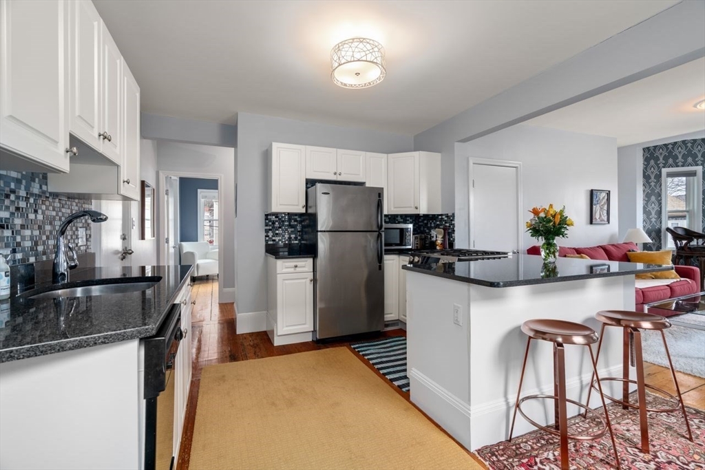 26 Armstrong Street, Unit 3 Boston, MA 02130 - Photo 4 of 17 a kitchen with refrigerator a stove and cabinets