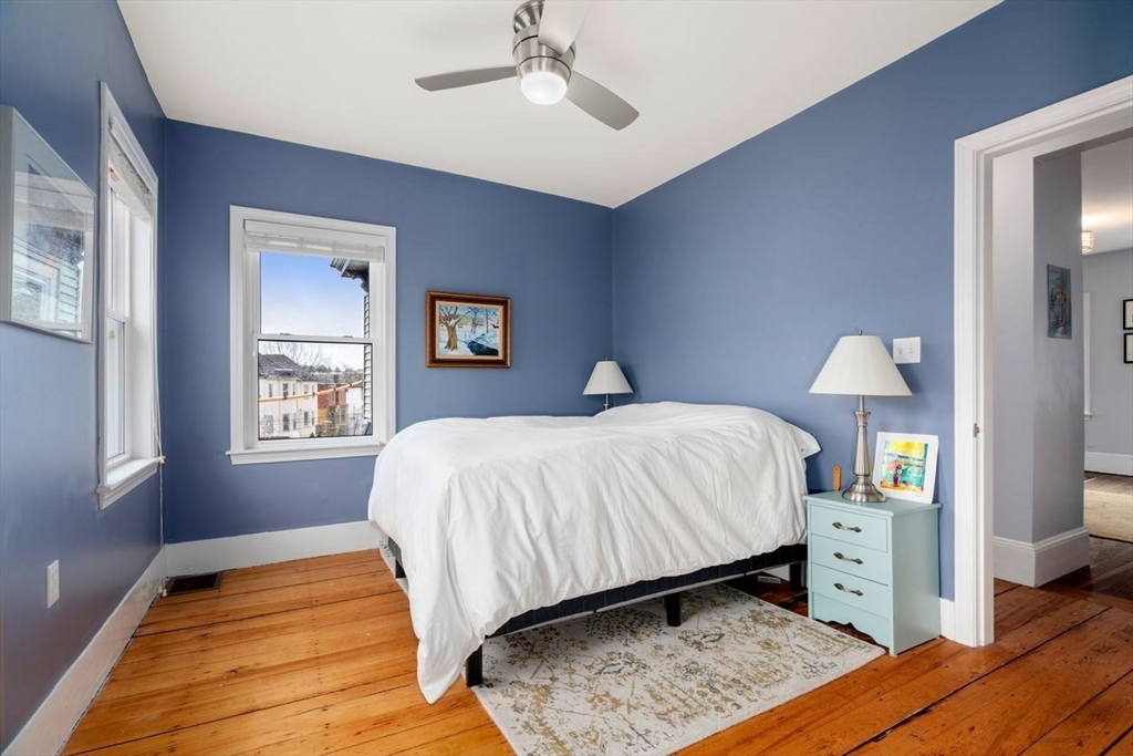26 Armstrong Street, Unit 3 Boston, MA 02130 - Photo 6 of 17 a bedroom with a bed and a chandelier