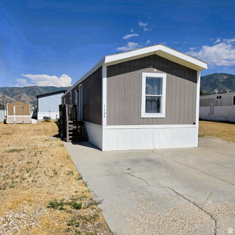 1604 180 East Tooele, UT 84074 - Photo 1 of 16 Single-story residence featuring gray horizontal siding and white trim