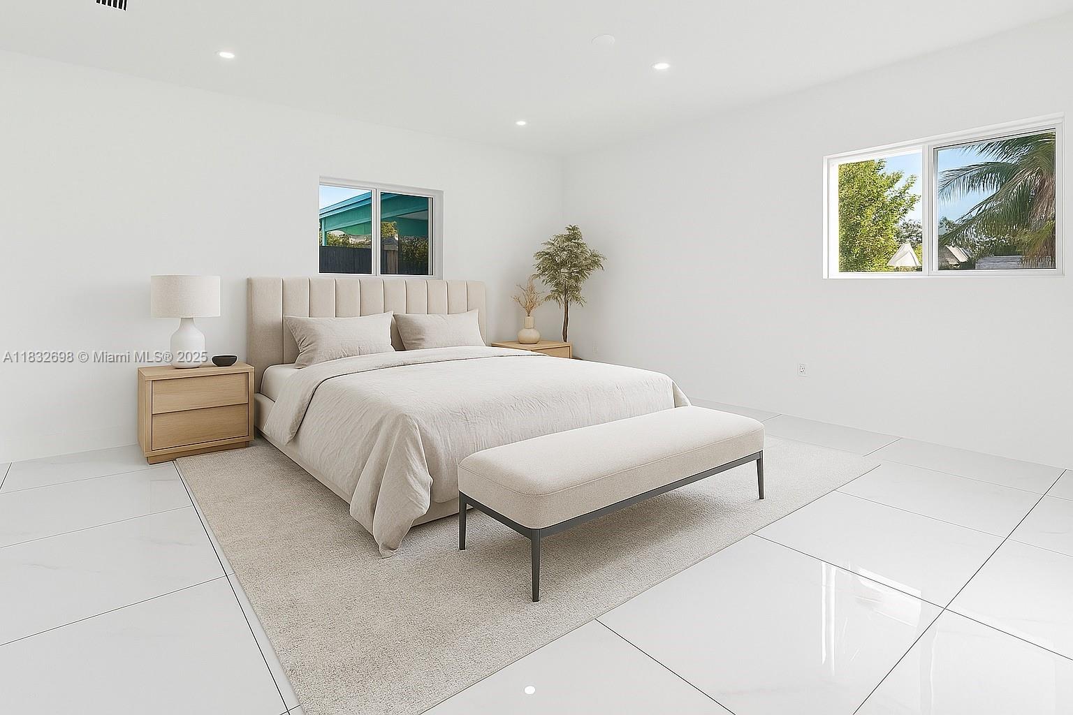 6540 Southwest 25th Street Miami, FL 33155 - Photo 14 of 37 a bedroom with a large bed and a potted plant