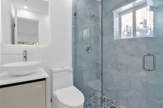 a kitchen with stainless steel appliances a refrigerator and cabinets