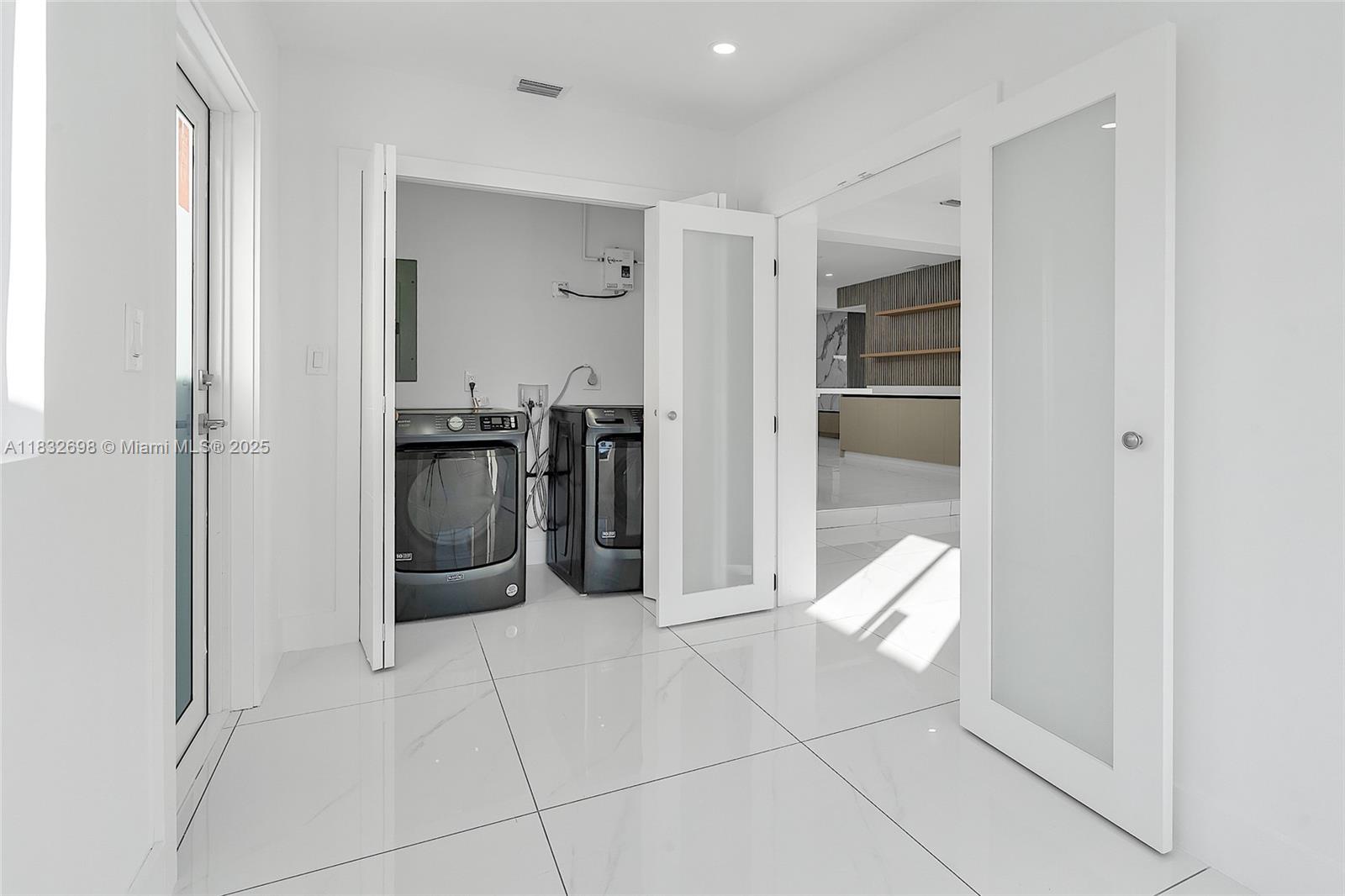 6540 Southwest 25th Street Miami, FL 33155 - Photo 26 of 37 a kitchen with stainless steel appliances a refrigerator and cabinets