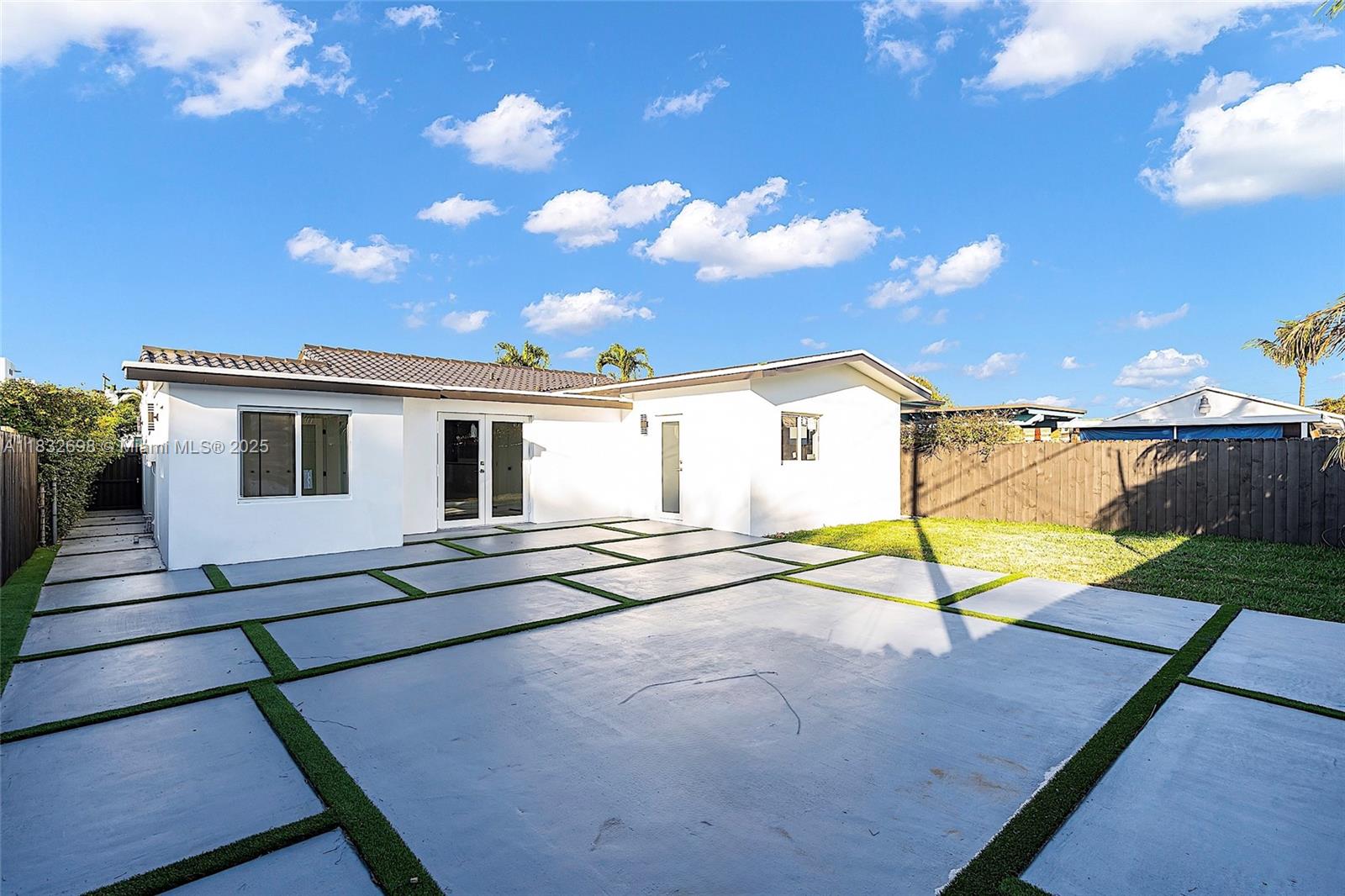 6540 Southwest 25th Street Miami, FL 33155 - Photo 29 of 37 a view of a house with a backyard and a patio