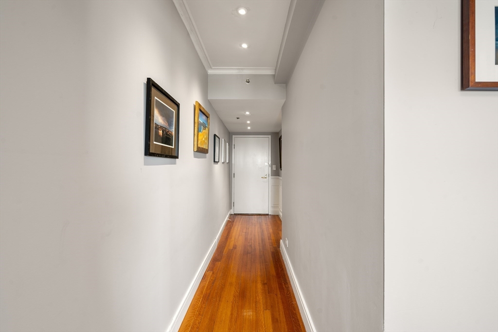 534 Beacon Street, Unit 707 Boston, MA 02215 - Photo 12 of 16 a view of a hallway with wooden floor