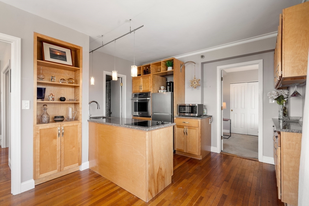 534 Beacon Street, Unit 707 Boston, MA 02215 - Photo 6 of 16 a kitchen with a refrigerator cabinets and wooden floor