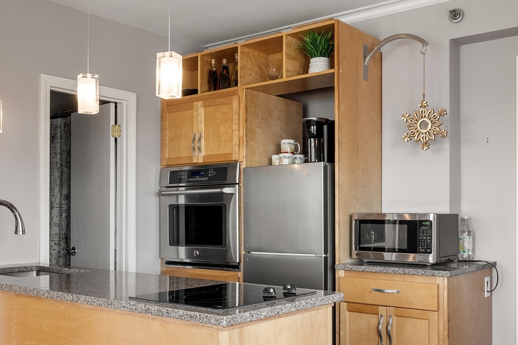 534 Beacon Street, Unit 707 Boston, MA 02215 - Photo 7 of 16 a kitchen with stainless steel appliances a stove microwave and a refrigerator