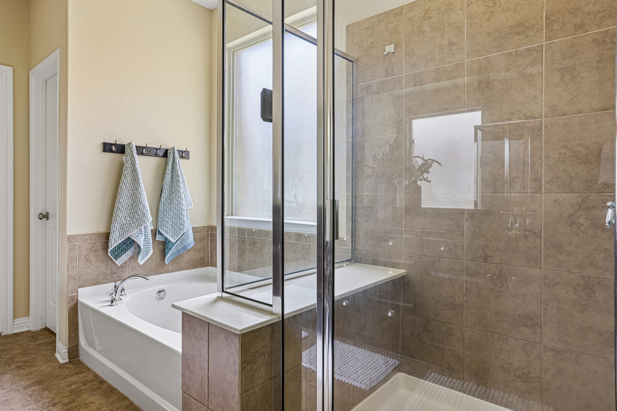 1924 Granite Springs Road Leander, TX 78641 - Photo 17 of 36 Indulge in this well-appointed bath, featuring a soaking tub and walk-in shower.