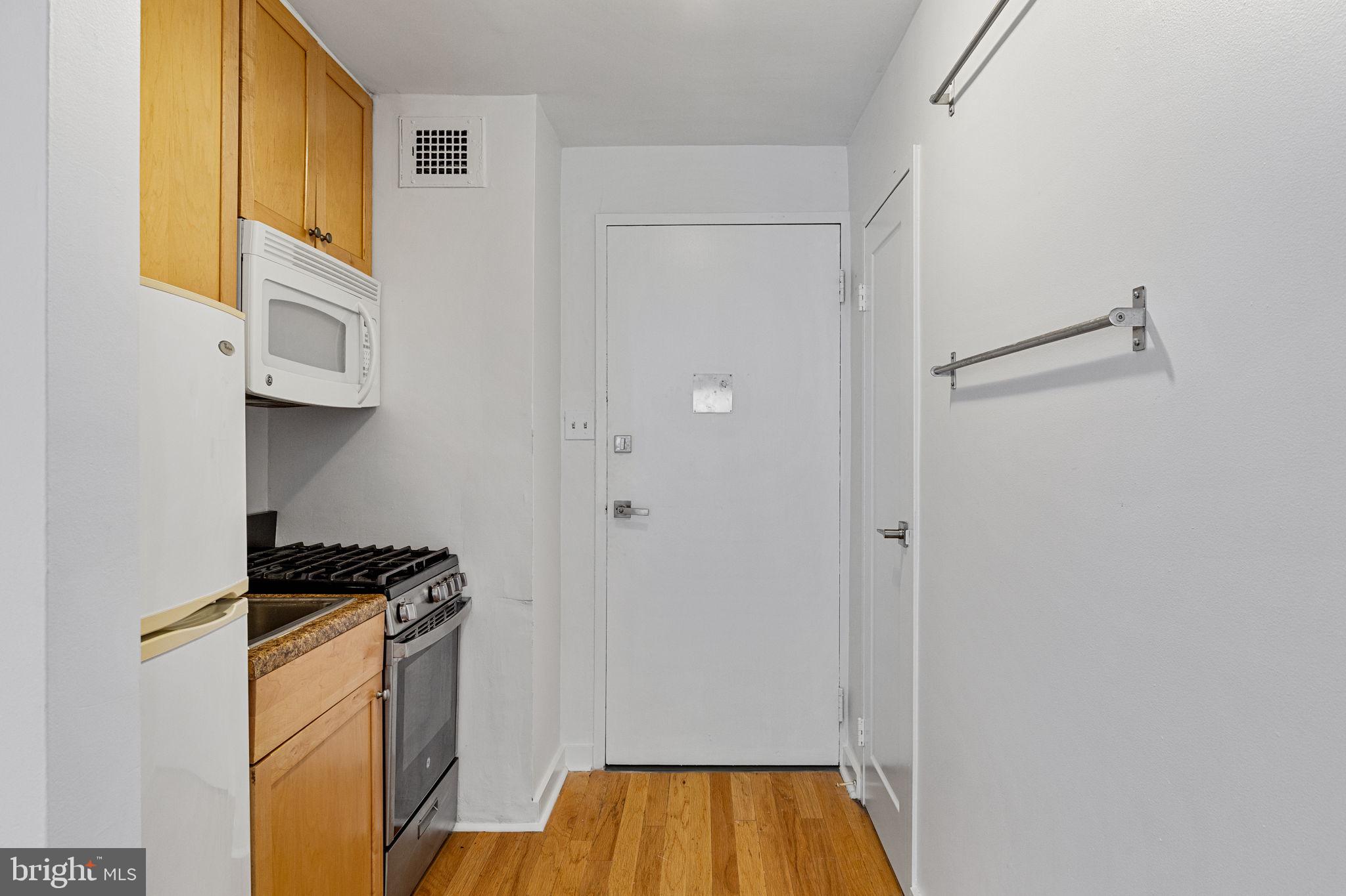 1810 Rittenhouse Square, Unit 203 Philadelphia, PA 19103 - Photo 2 of 15 a kitchen with a refrigerator and a stove top oven