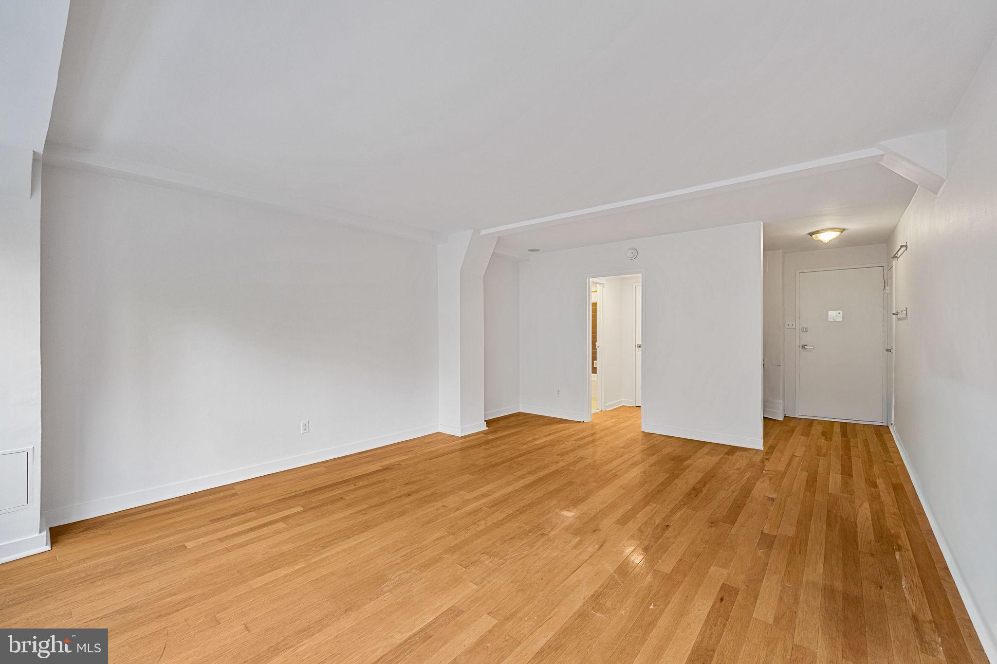 1810 Rittenhouse Square, Unit 203 Philadelphia, PA 19103 - Photo 4 of 15 a view of empty room with wooden floor and fan