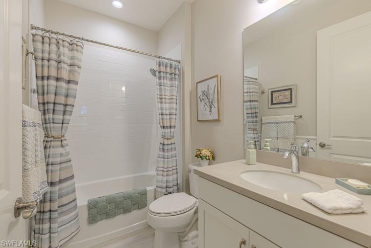 2199 Marquesa Circle Naples, FL 34112 - Photo 11 of 26 Bathroom featuring shower / tub combo, vanity, and recessed lighting