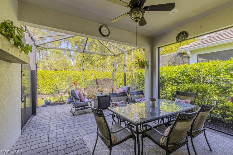 2199 Marquesa Circle Naples, FL 34112 - Photo 15 of 26 View of patio / terrace with a lanai, a sunroom, outdoor dining space, and ceiling fan