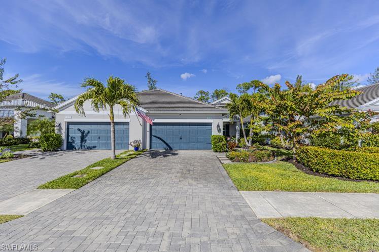 2199 Marquesa Circle Naples, FL 34112 - Photo 20 of 26 Ranch-style home featuring driveway, a tiled roof, an attached garage, and stucco siding