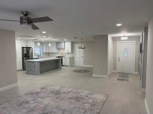 a view of a kitchen with a sink and cabinets