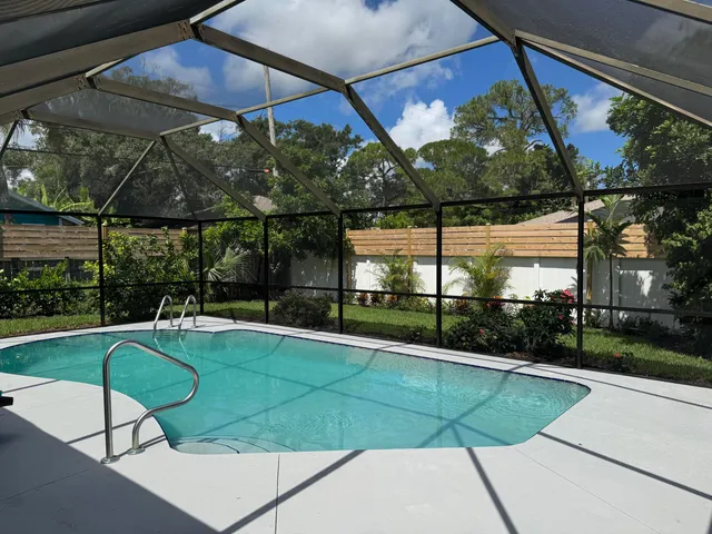 a view of a backyard with a swimming pool