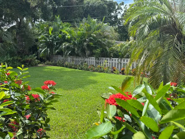 a view of a flower in a garden with sitting area
