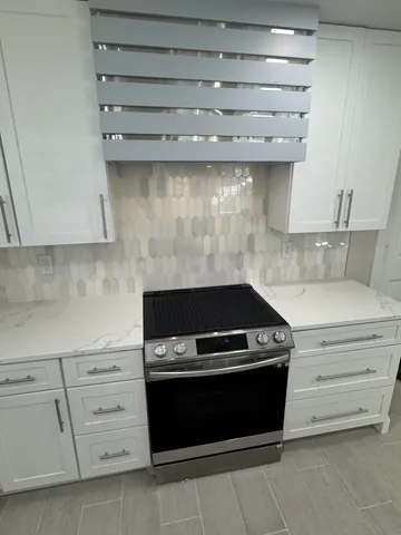 a stove top oven sitting inside of a kitchen