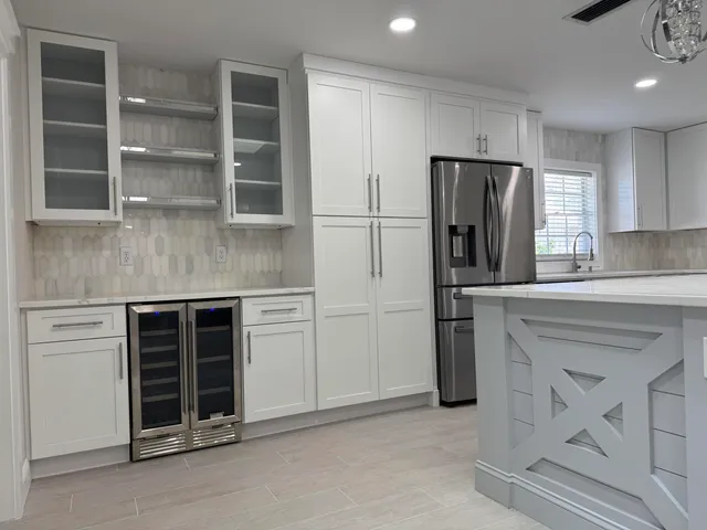 a kitchen with stainless steel appliances a refrigerator sink and cabinets