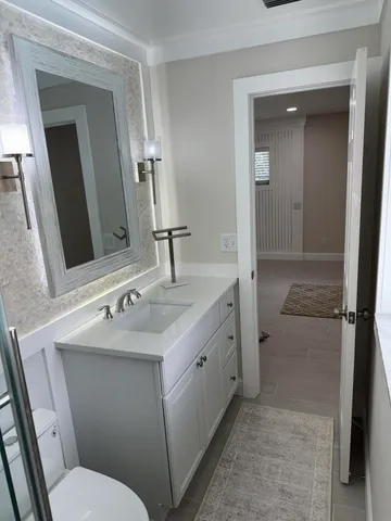 a bathroom with a sink toilet and shower