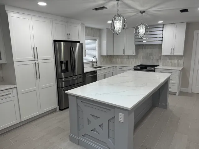 a kitchen with refrigerator cabinets and wooden floor