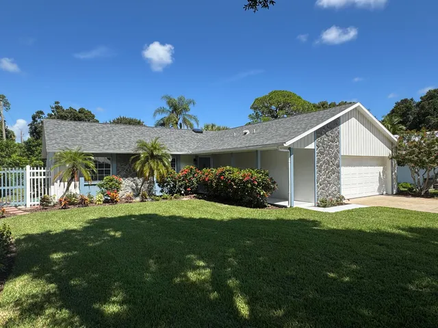 a view of a house with a yard and porch
